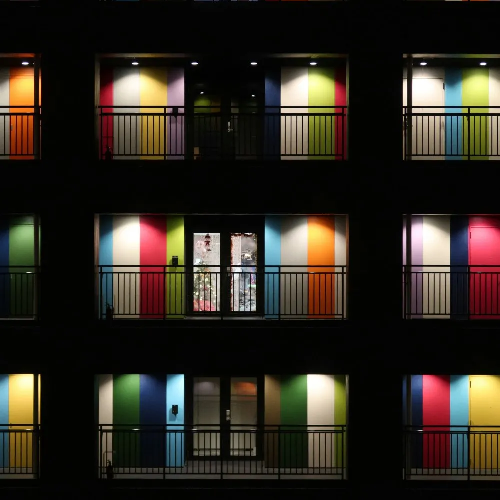 A grid of lit doorways at night, each one an entry point