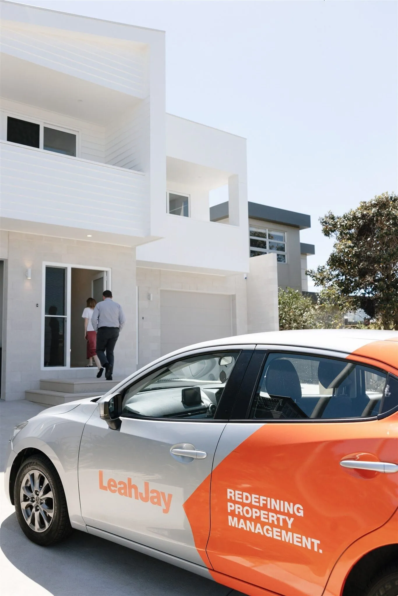 Leah Jay property managers arriving at a home, with a Leah Jay car outside
