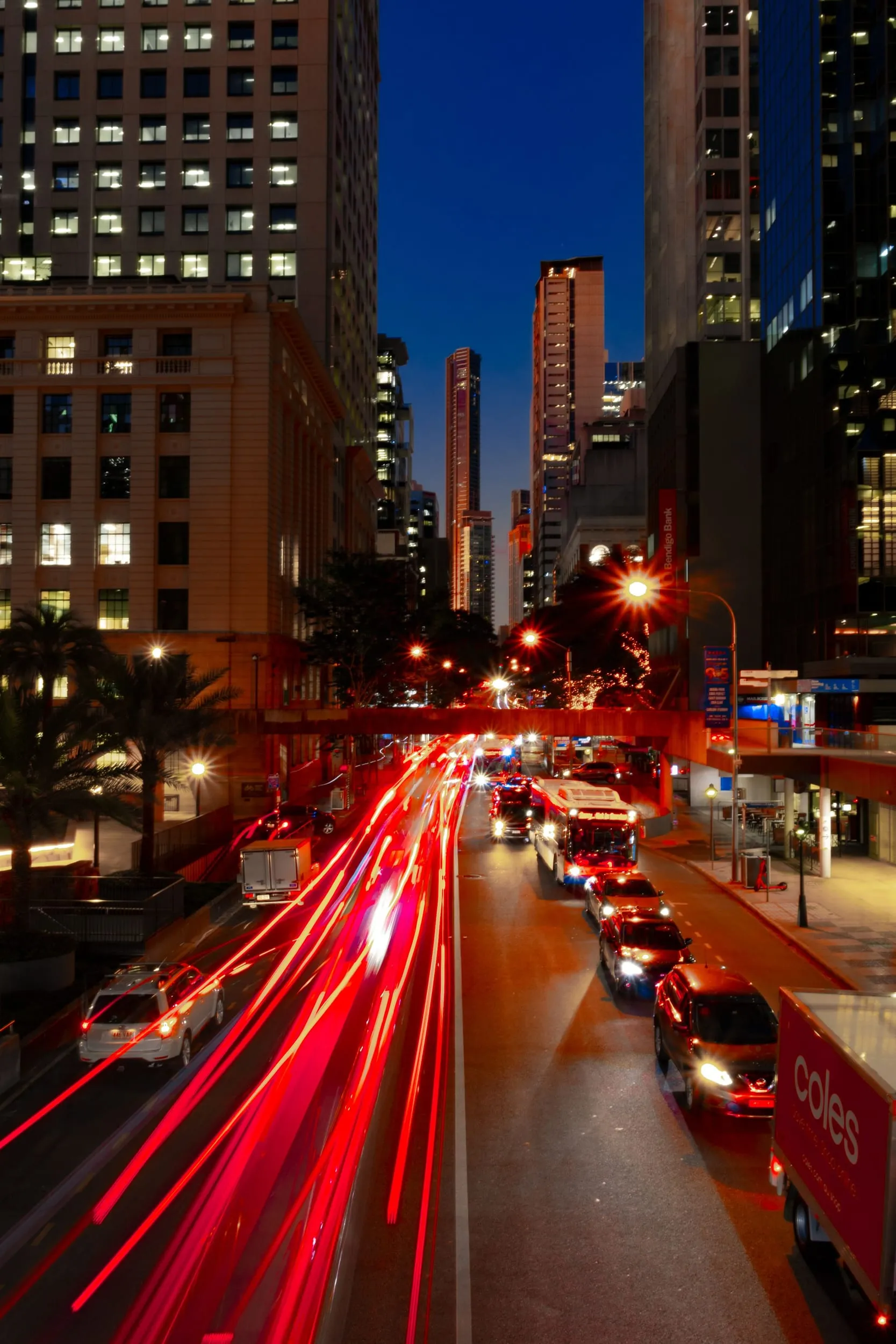 Traffic light trails through a Brisbane street at night