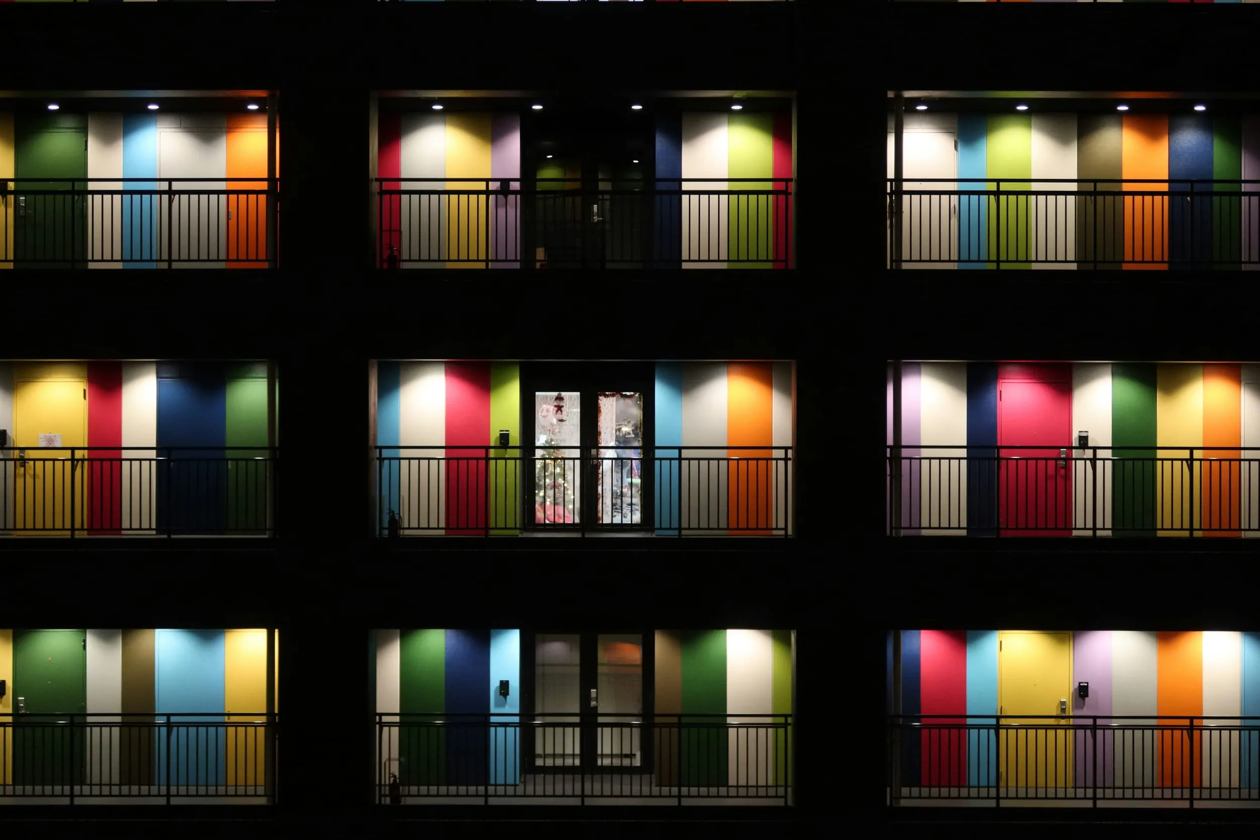 A grid of lit balconies at night