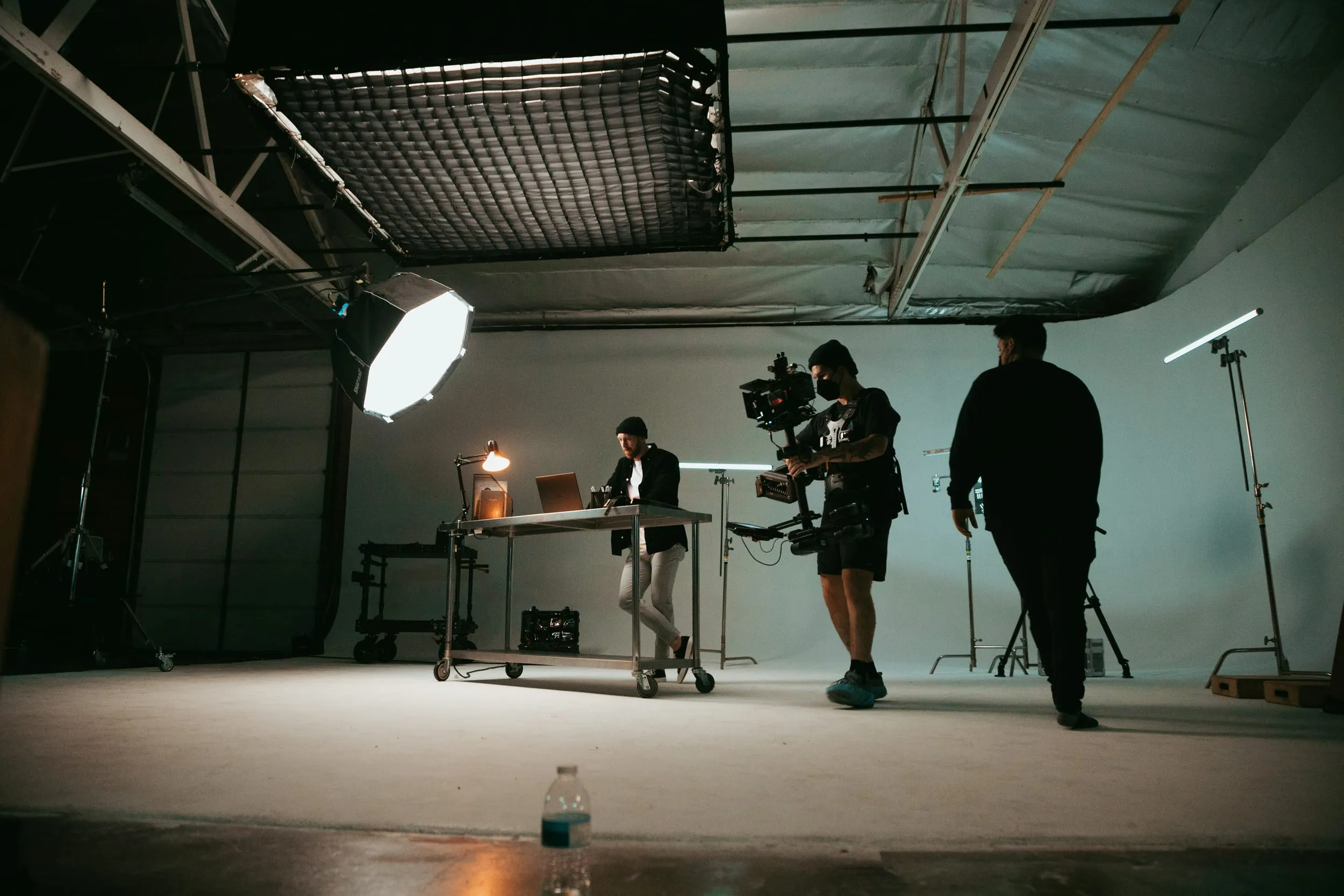 A crew working on a lit studio set
