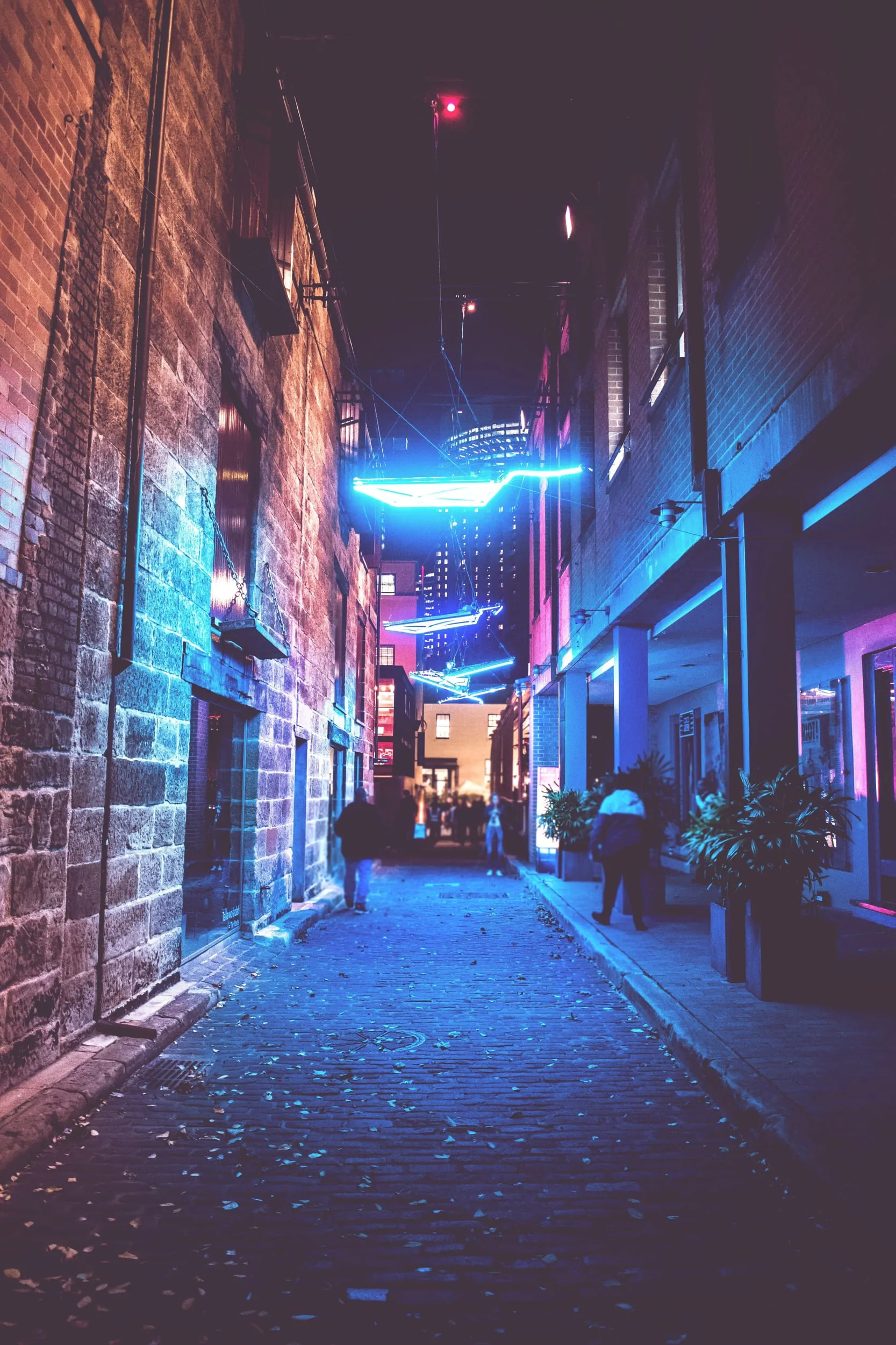 A blue-lit laneway at night