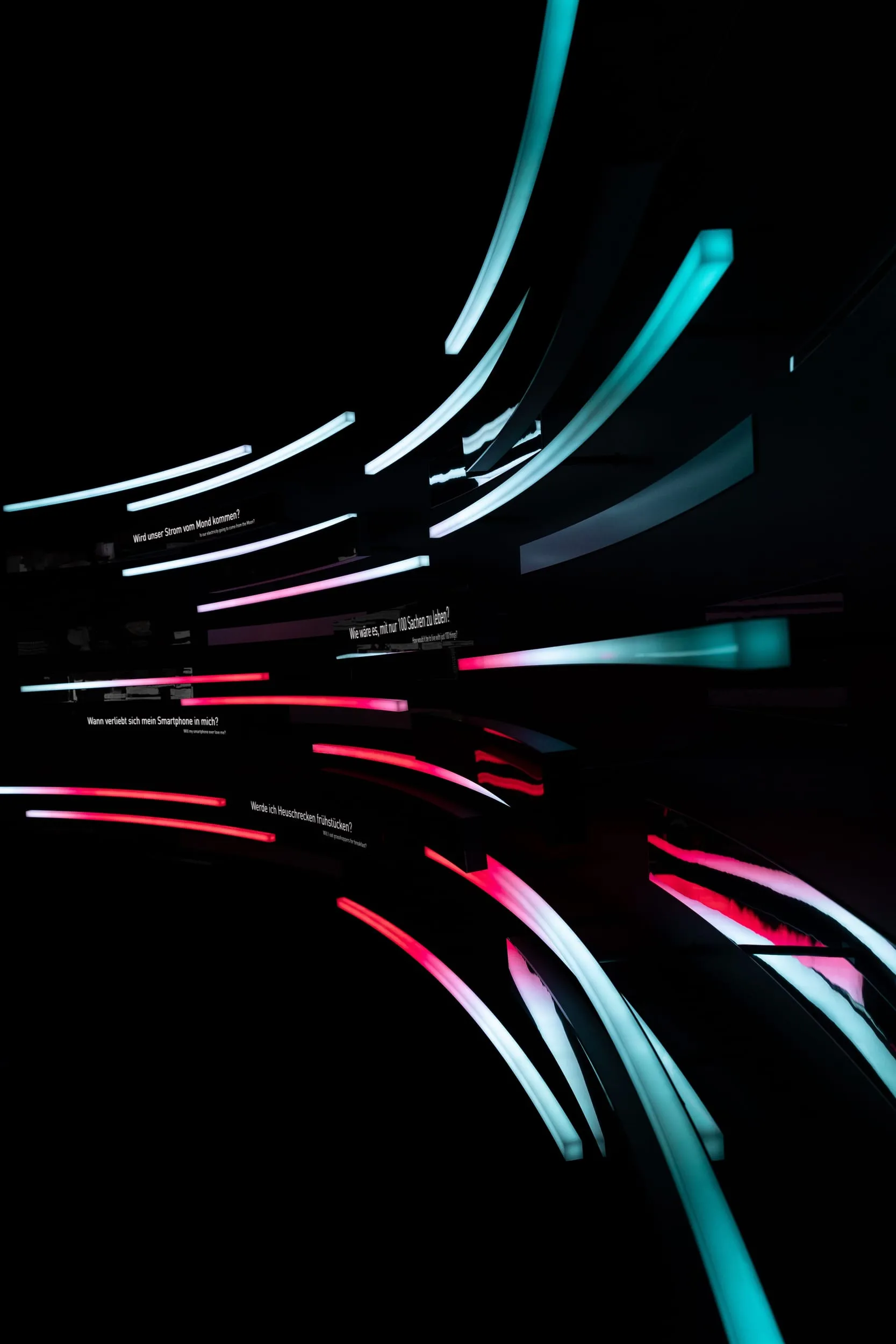Lit tubes carrying questions in a dark room