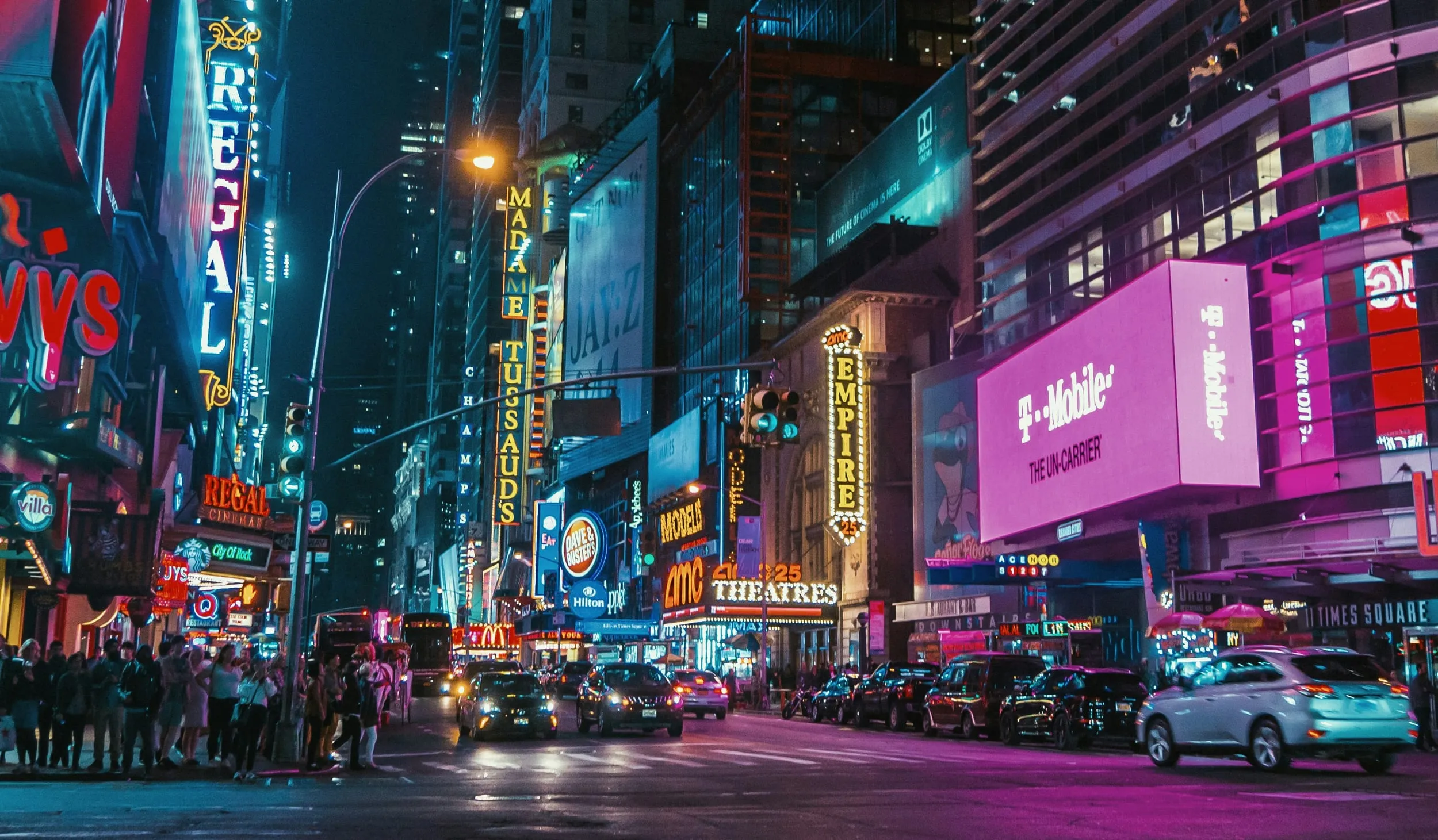 Screens above a crowd at night