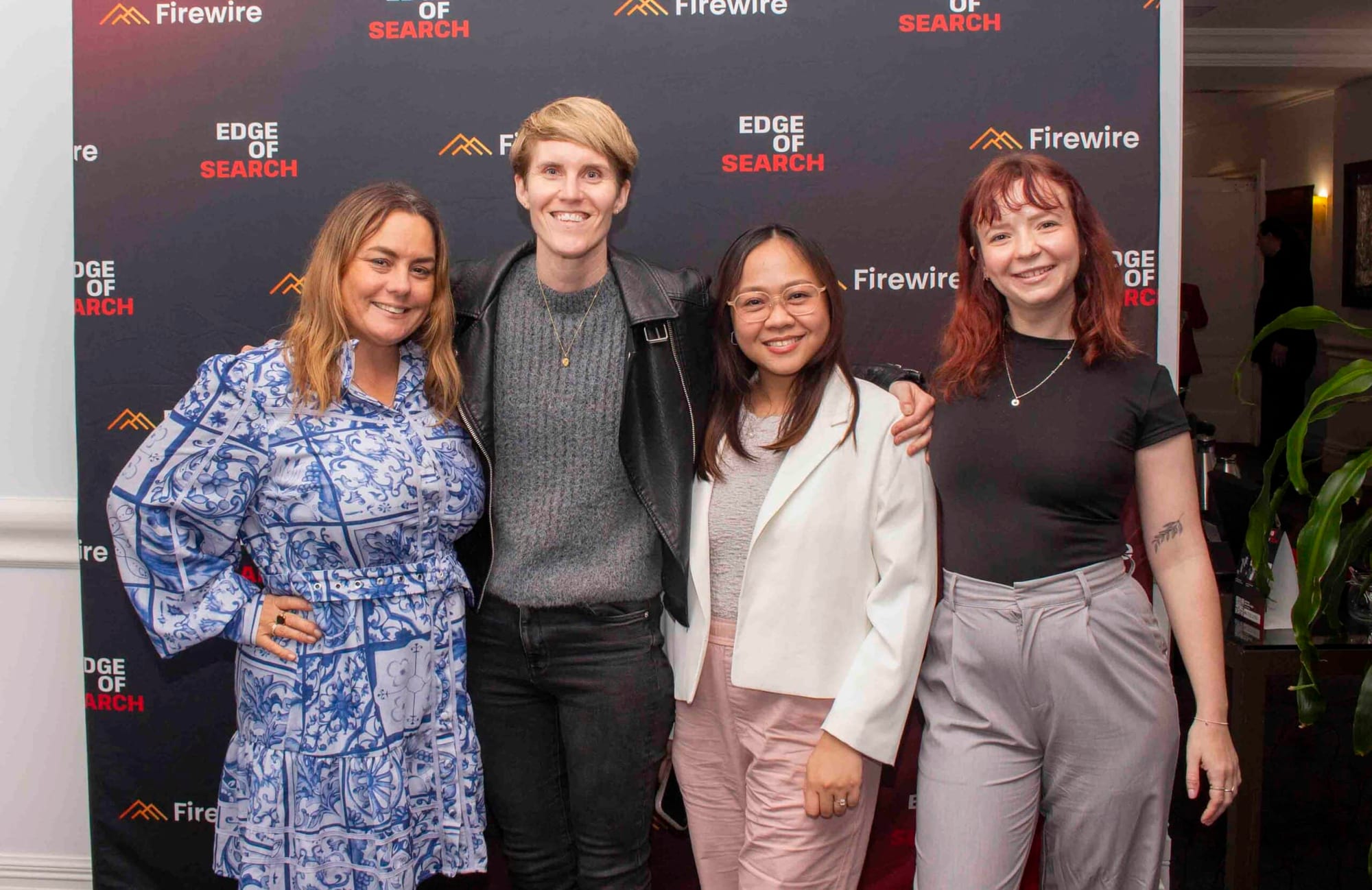Attendees in front of the Edge of Search and Firewire media wall at the 2024 conference